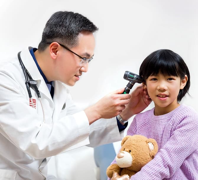 Doctor examining a little girl